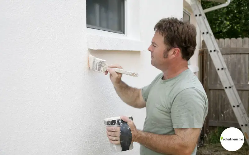 Image of exterior painter paint whit house wall