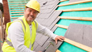 Roofer fixing a roof tile