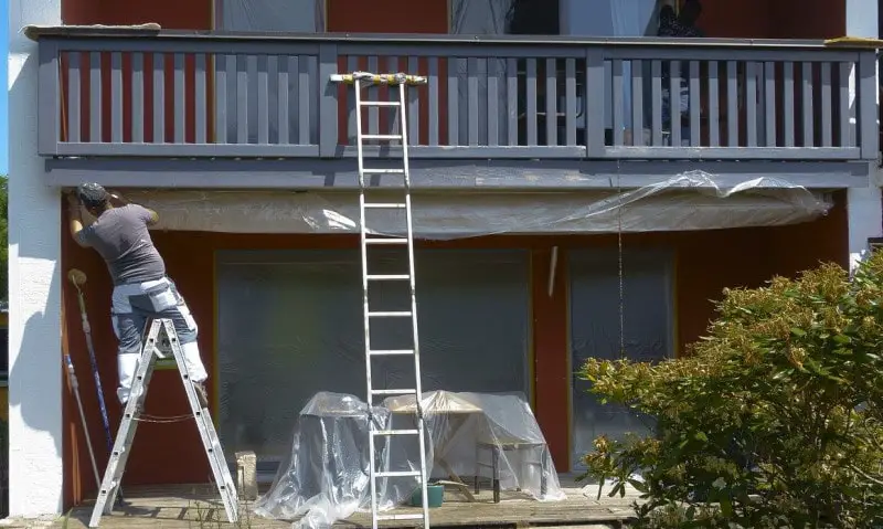Image of painter using ladder