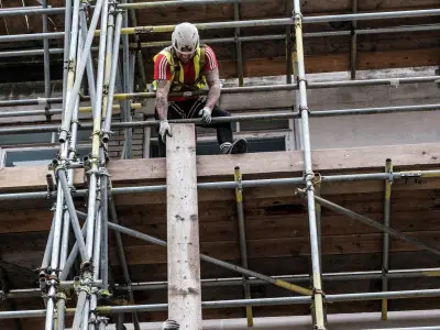 Scaffolders erecting scaffold